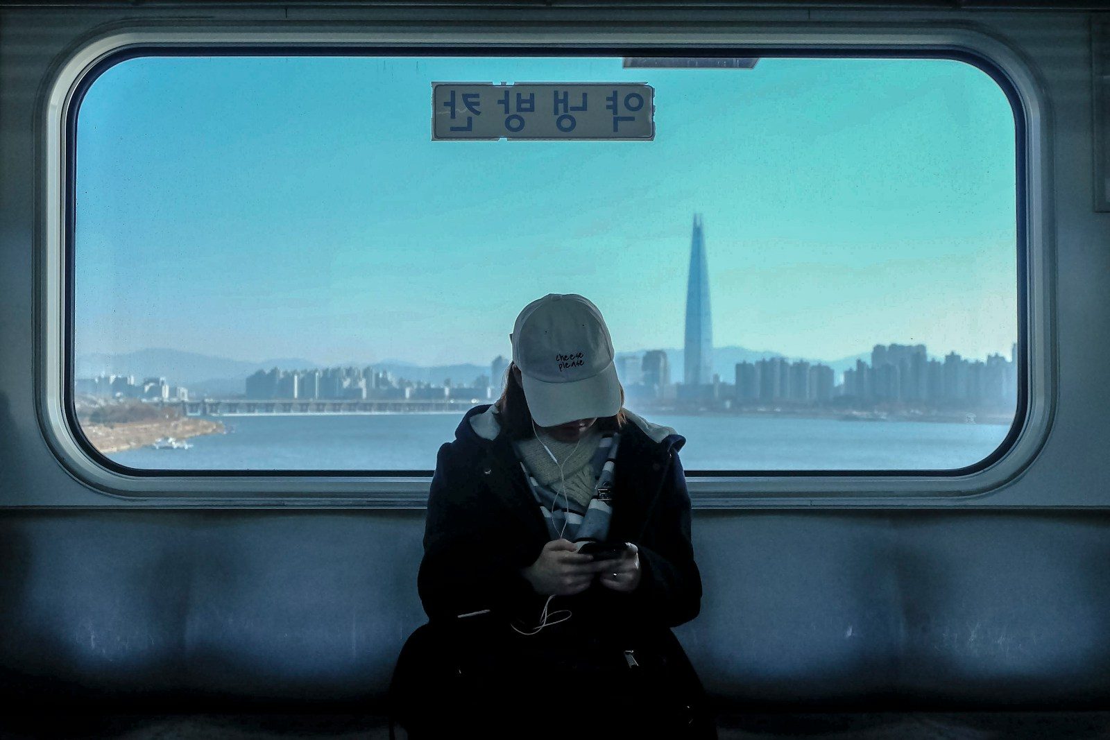woman wearing coat and earbuds
